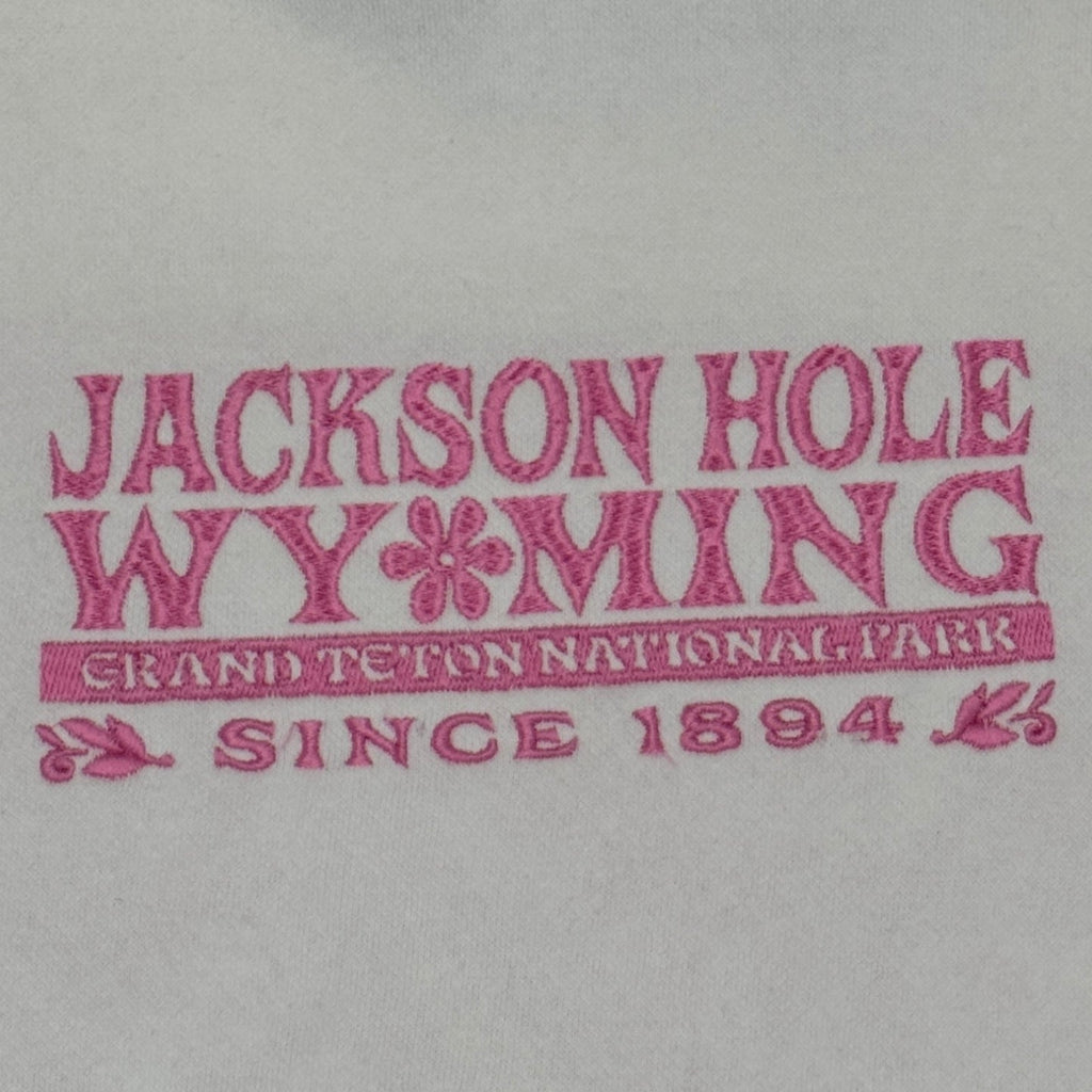 Light gray hoodie with 'Jackson Hole Wyoming' text in red on a white background