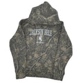 Camouflage-patterned hoodie with branding inside a gray bag on a white background