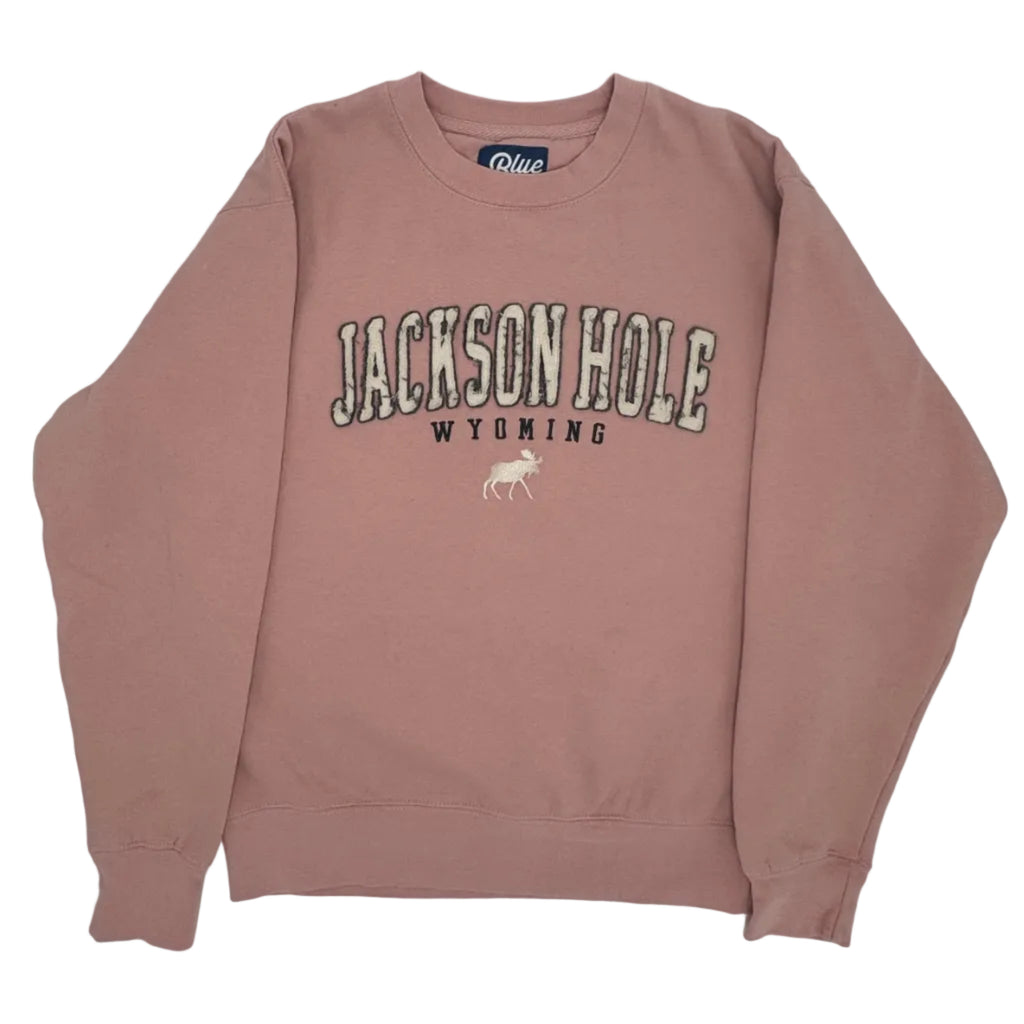 Pink sweatshirt with 'Jackson Hole, Wyoming' text on a white background